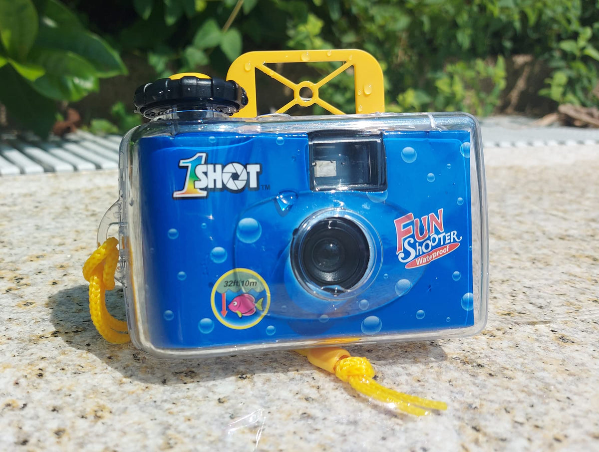1 Shot camera held in hand to show size and travel-ready portability