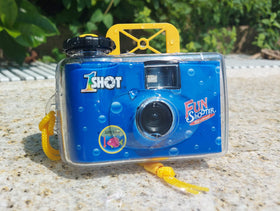 1 Shot camera held in hand to show size and travel-ready portability