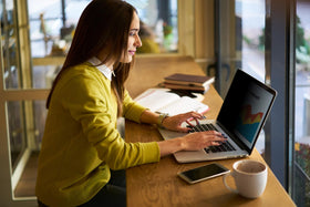 Adhesive strips applied to secure 3M privacy filter on laptop screen