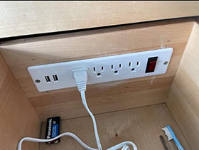 4 LEAF USB power strip integrated into workbench for quick access.