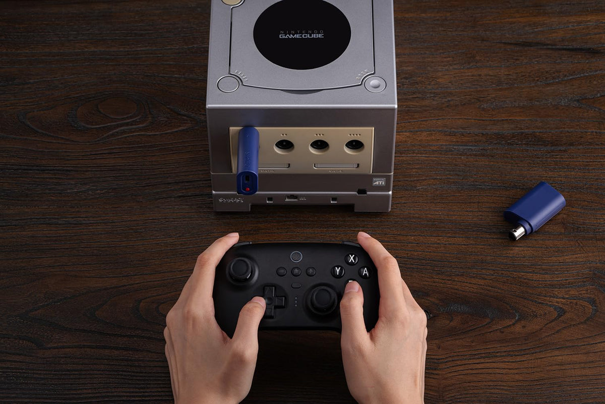 8BitDo receiver paired with PS5 controller held in hand for comfortable modern play