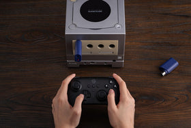 8BitDo receiver paired with PS5 controller held in hand for comfortable modern play