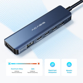 ACASIS hub next to laptop showing scale for portability and travel convenience