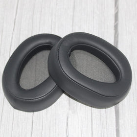 Adhiper ear pad next to coin indicates compact size and accurate fit