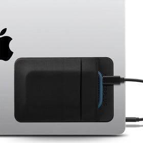 Afterplug two-pocket adhesive holder close-up on laptop keeps drives within reach