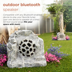Alpine rock speaker solar patio scene showing outdoor audio for gatherings