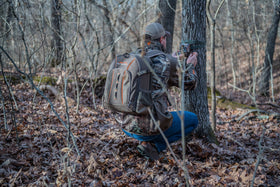 Lower side pocket holds pruners and a limb saw for field prep.