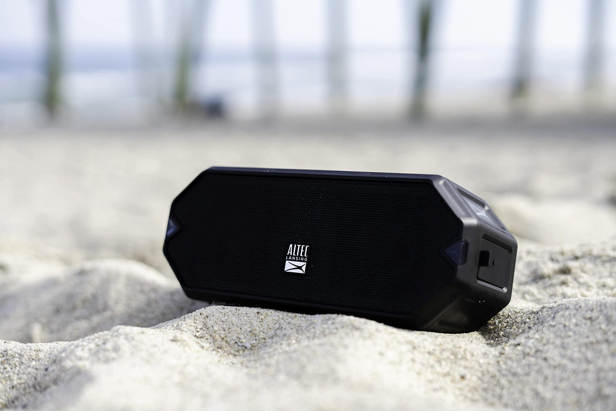 Altec Lansing held in hand for scale, compact portability advantage