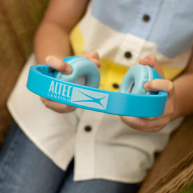 Altec Lansing headphones next to toy showing scale and kid-friendly portability benefit