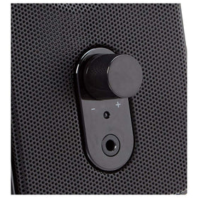 Amazon Basics speakers with front volume control and power/standby switch.