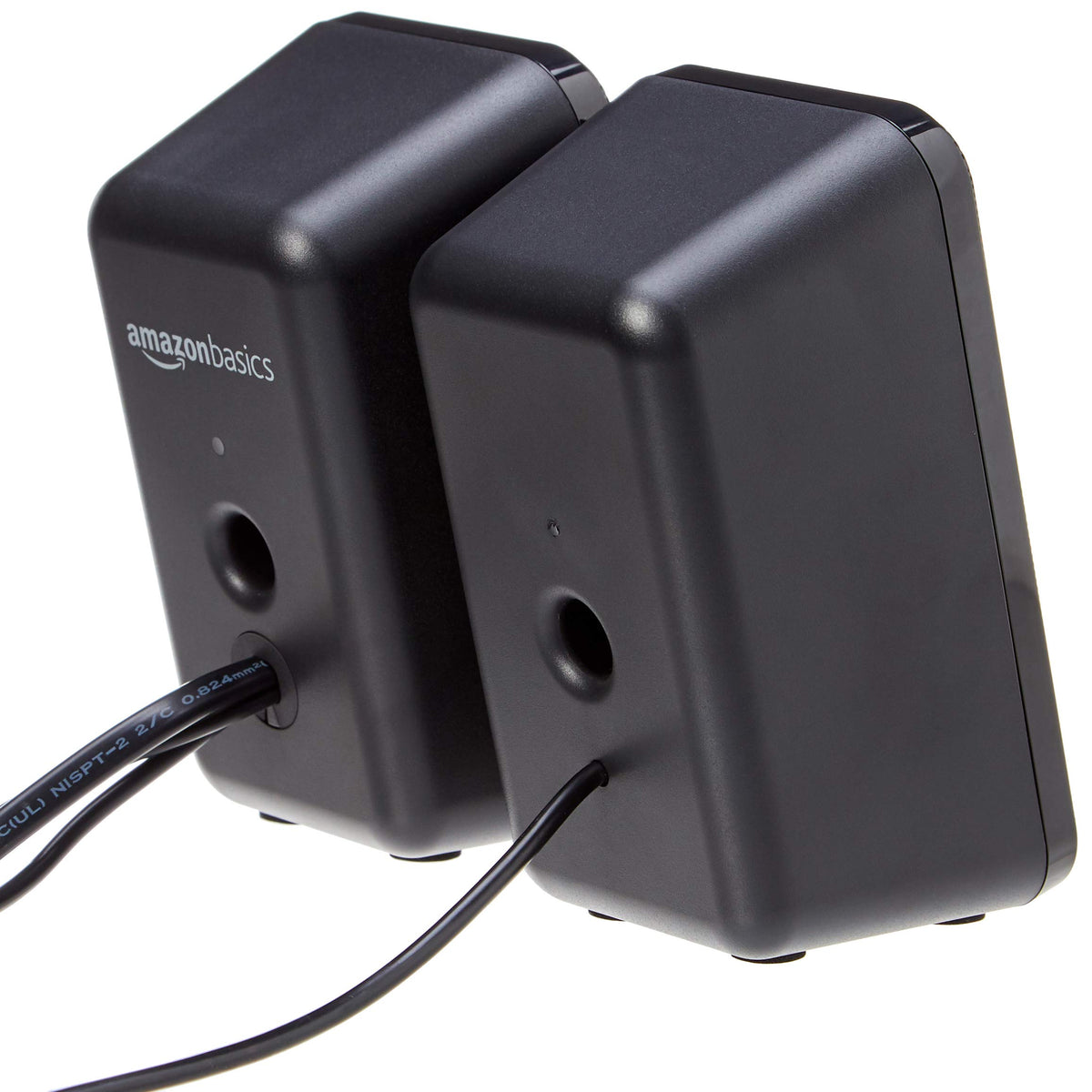 Amazon Basics speaker side view showing compact footprint and wall outlet power connection.