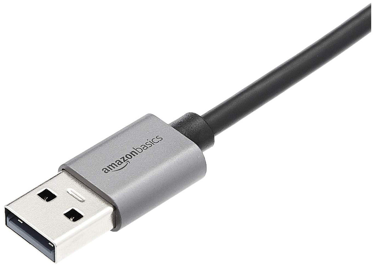 Amazon Basics USB 3.0 aluminum Ethernet adapter on laptop, portable for travel.