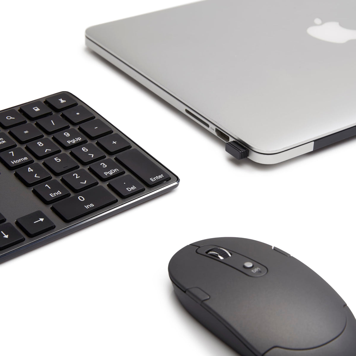 Amazon Basics keyboard and mouse next to laptop showing compact scale benefit