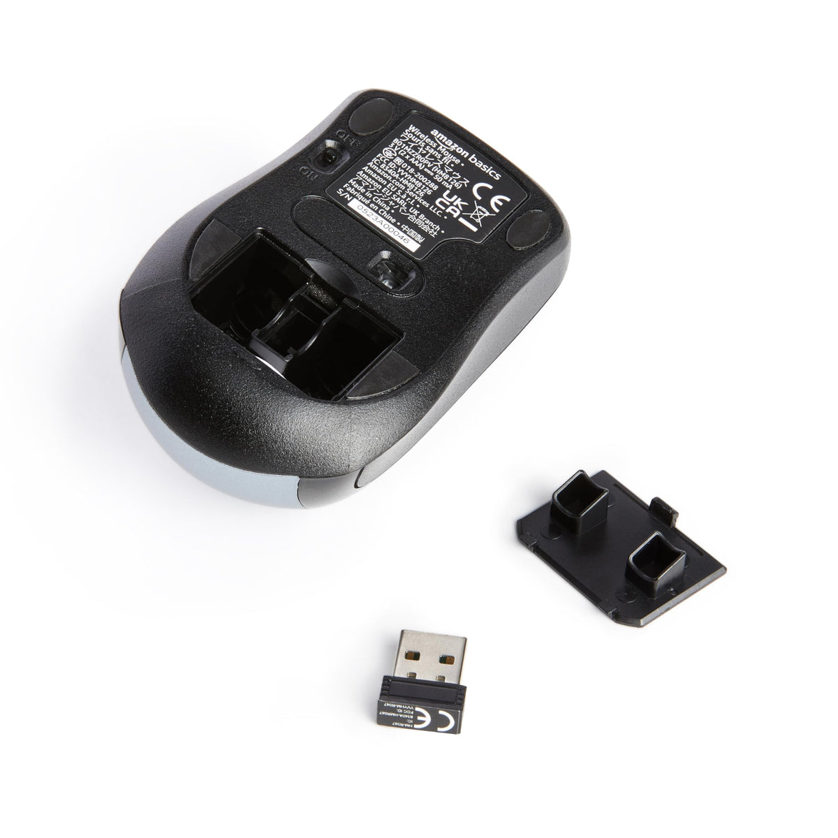 Amazon Basics wireless mouse silver receiver-storage view shows USB nano receiver tucked inside.