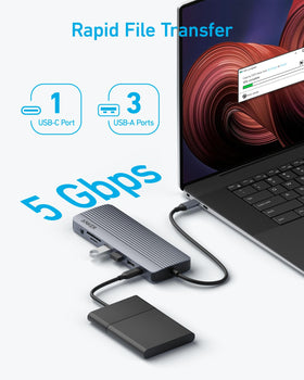 Anker beside a laptop to show size and 80W charging convenience