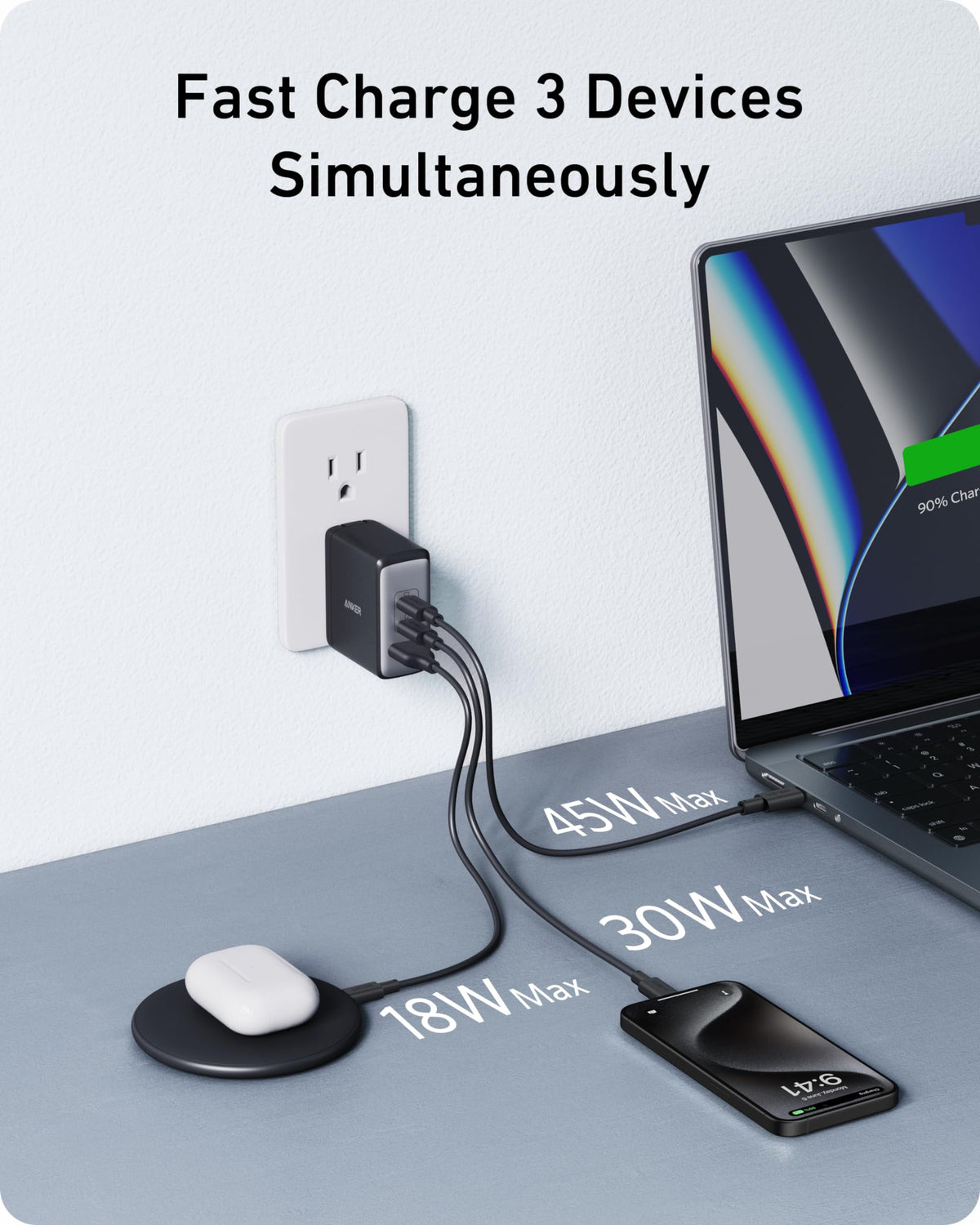 Anker Nano 100W charging laptop, phone, and earbuds simultaneously showcasing versatility