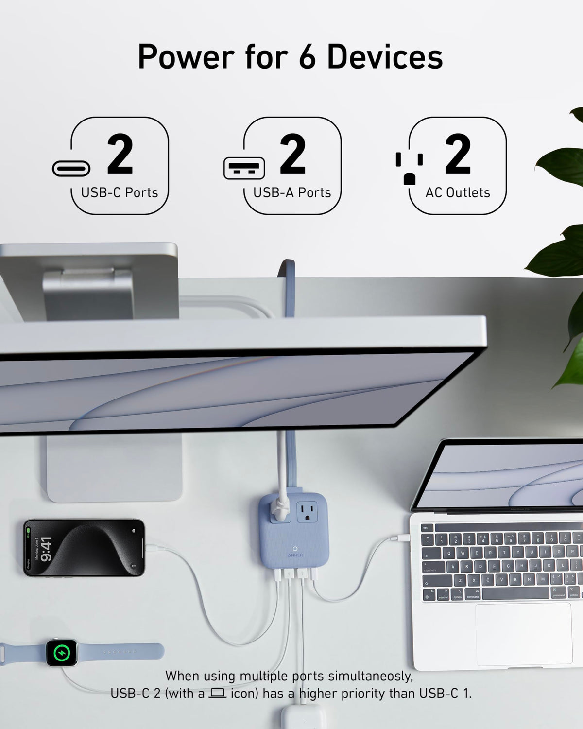 Anker Nano powering laptop and phone on a hotel desk for convenient travel charging