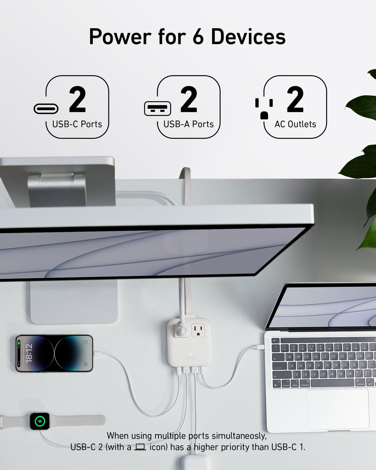 Anker power strip in hotel room powering laptop and phone, reduces clutter