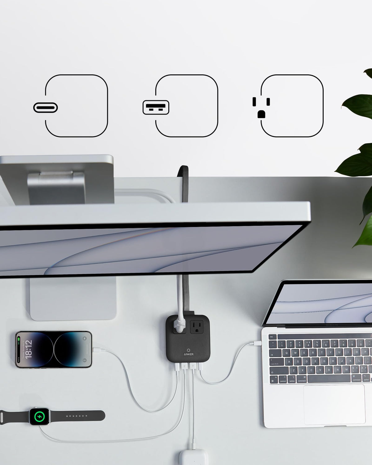 Anker Nano on a bedside table powering laptop and phone for travel convenience