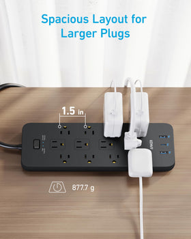 Anker power strip plugged into desk setup powering monitor and accessories neatly