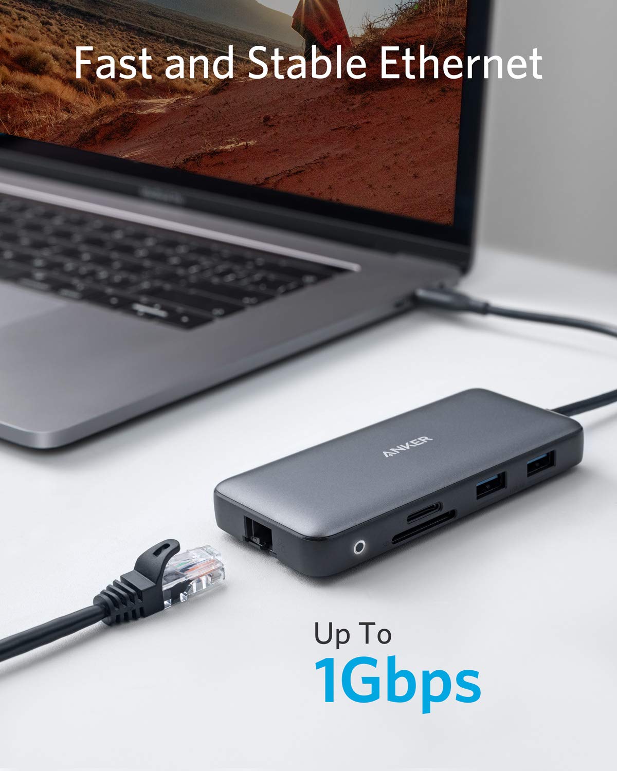 Anker next to laptop showing compact scale to save desk space and stay portable