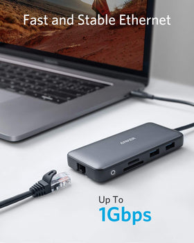 Anker next to laptop showing compact scale to save desk space and stay portable