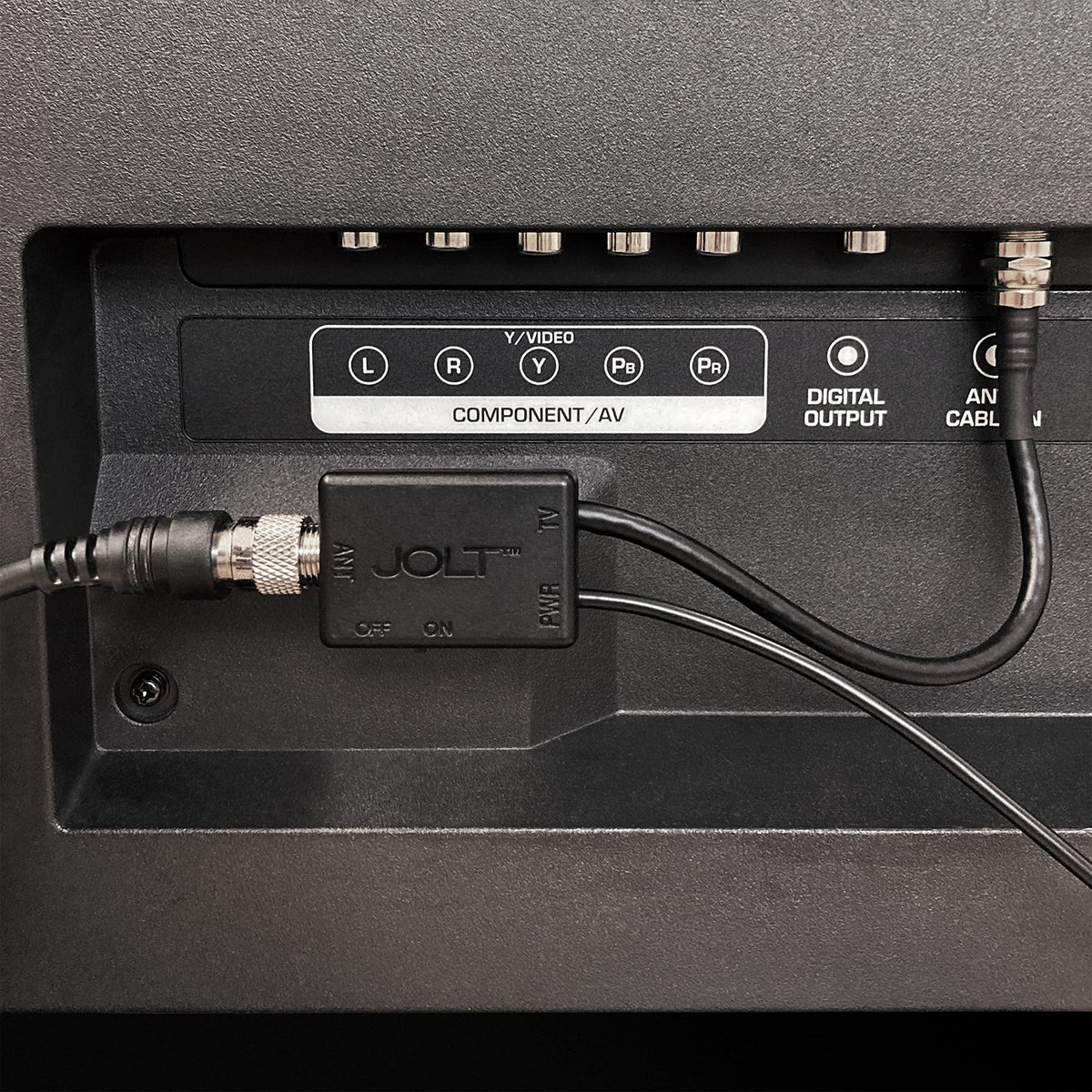 Antennas Direct Jolt Switch installed behind a TV using USB power adapter to improve antenna signal
