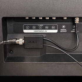 Antennas Direct Jolt Switch installed behind a TV using USB power adapter to improve antenna signal