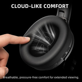 AOC headphones held next to hand for scale, shows compact portable size