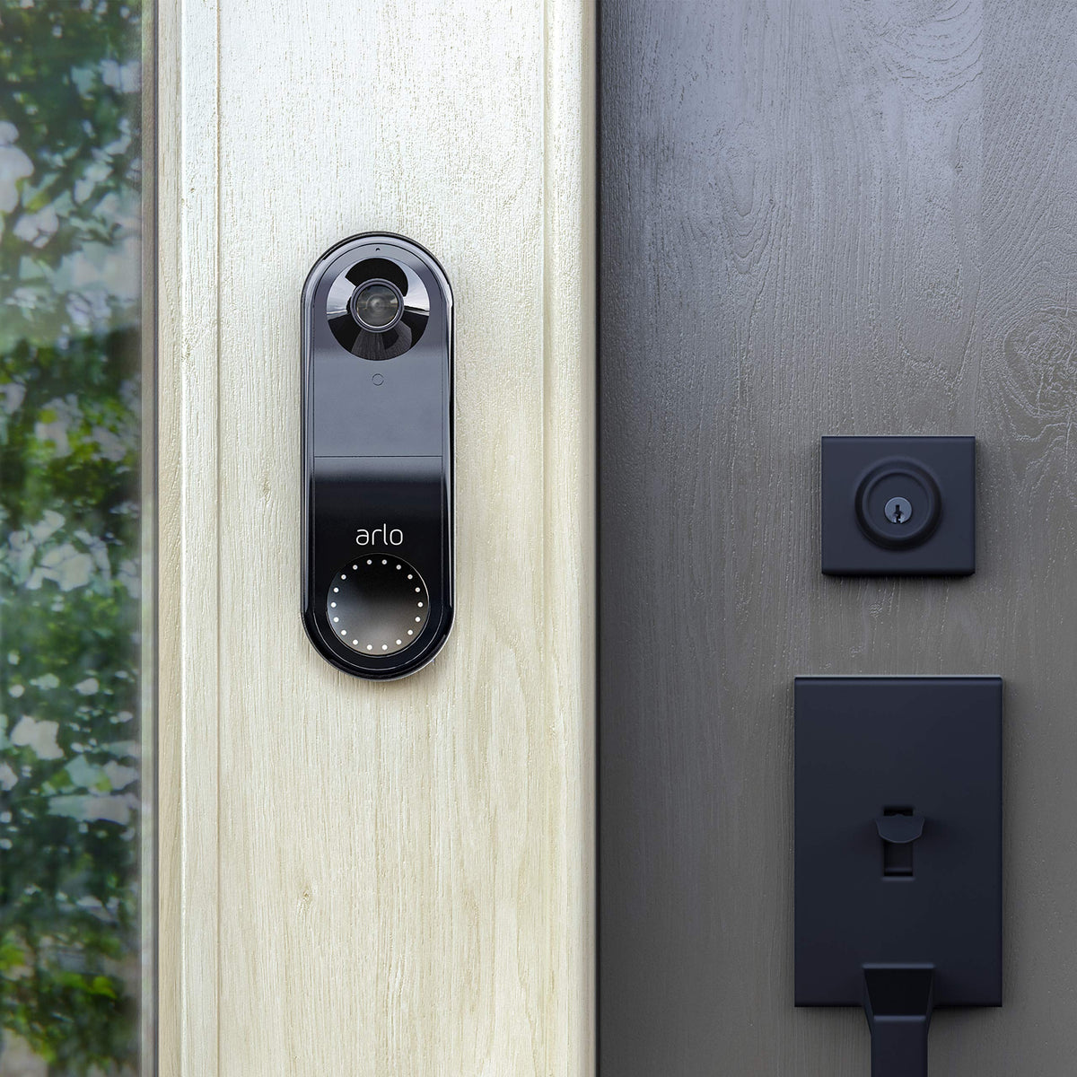 Arlo doorbell beside a hand for scale to show compact size and discreet appearance benefit