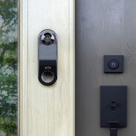 Arlo doorbell beside a hand for scale to show compact size and discreet appearance benefit