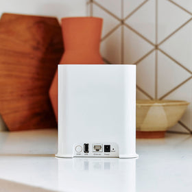 Arlo SmartHub placed in yard with camera illustrating extended range benefit