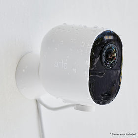 Arlo cable beside an outlet for scale showing easy reach to household power