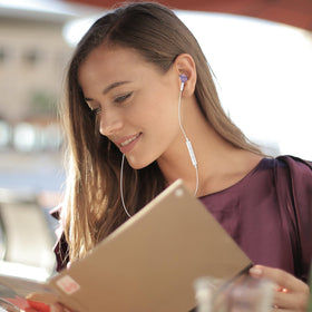ASKUBSKU earbuds used by commuter on bus, showing convenience and hands-free calls