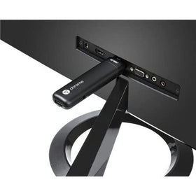 ASUS Chromebit CS10 on a desk turns a display into a computer-friendly workstation.