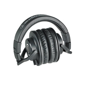 Audio-Technica headphone stand on a desk for organized workspace.