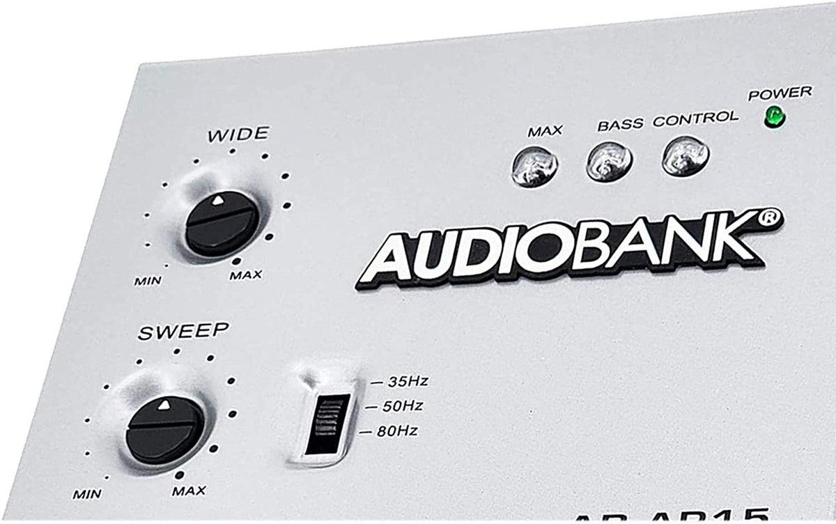 Audiobank AP15 mounted in car trunk with amplifier showing real-world installed bass enhancement