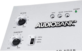 Audiobank AP15 mounted in car trunk with amplifier showing real-world installed bass enhancement