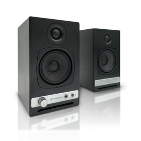 Audioengine A2-HD desk setup showing compact, room-filling desktop speakers.