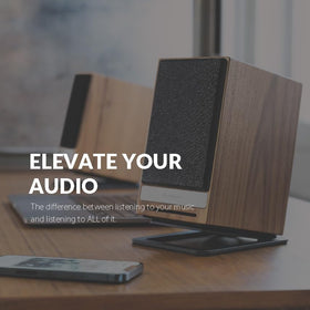 Audioengine DS1M next to a compact speaker demonstrating size fit and space-saving benefit