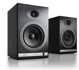 Audioengine HD5 woofers close-up showing 5.5-inch drivers delivering room-filling bass.