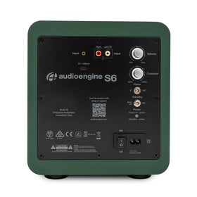 Audioengine S6 compact-design subwoofer tucked under furniture for space-saving bass.