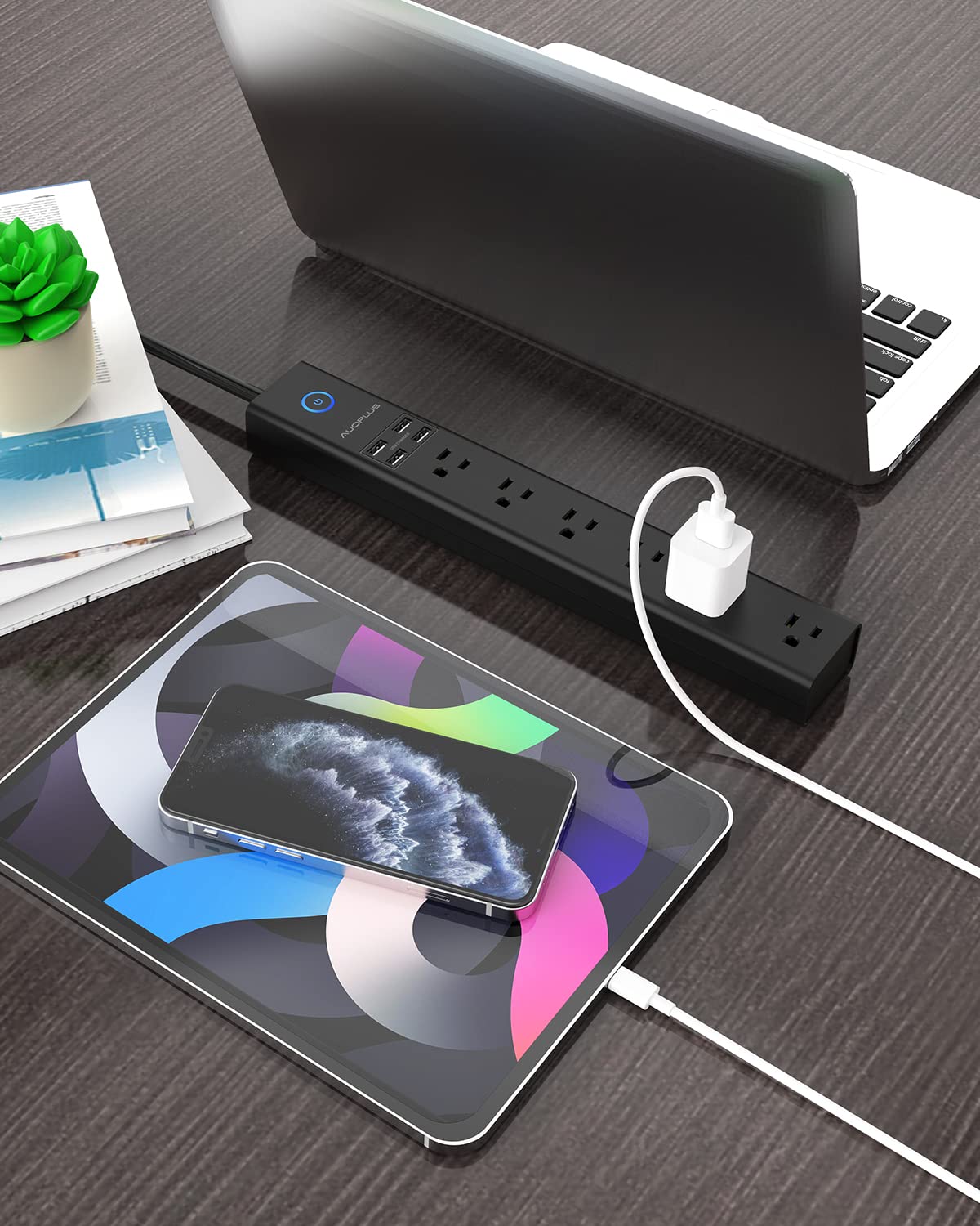 AUOPLUS in desk setup powering laptop, phone, lamp showing compact multi-device use