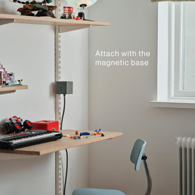 AVOLT Square 1 adhesive magnetic mount placed under a desk.