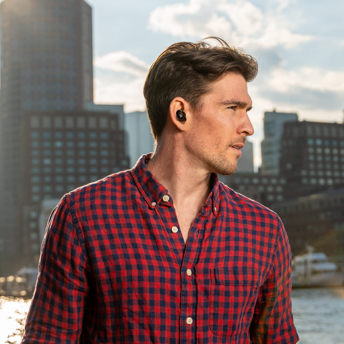 Back Bay Audio earbuds worn by a runner, emphasizes stable fit during workouts