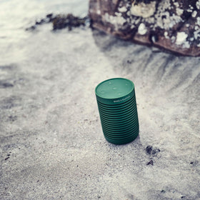 Non-slip base keeps Beosound Explore steady on wet or uneven surfaces outdoors.