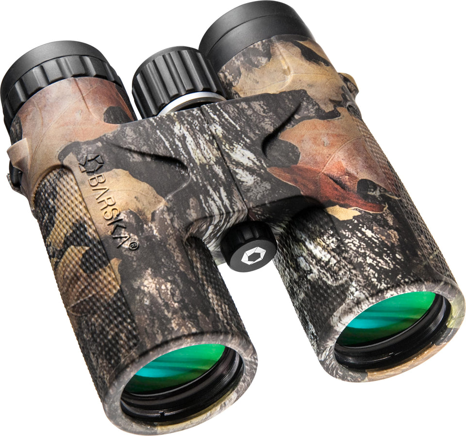 Barska Blackhawk binoculars in mossy oak camouflage for wildlife viewing in rugged terrain.