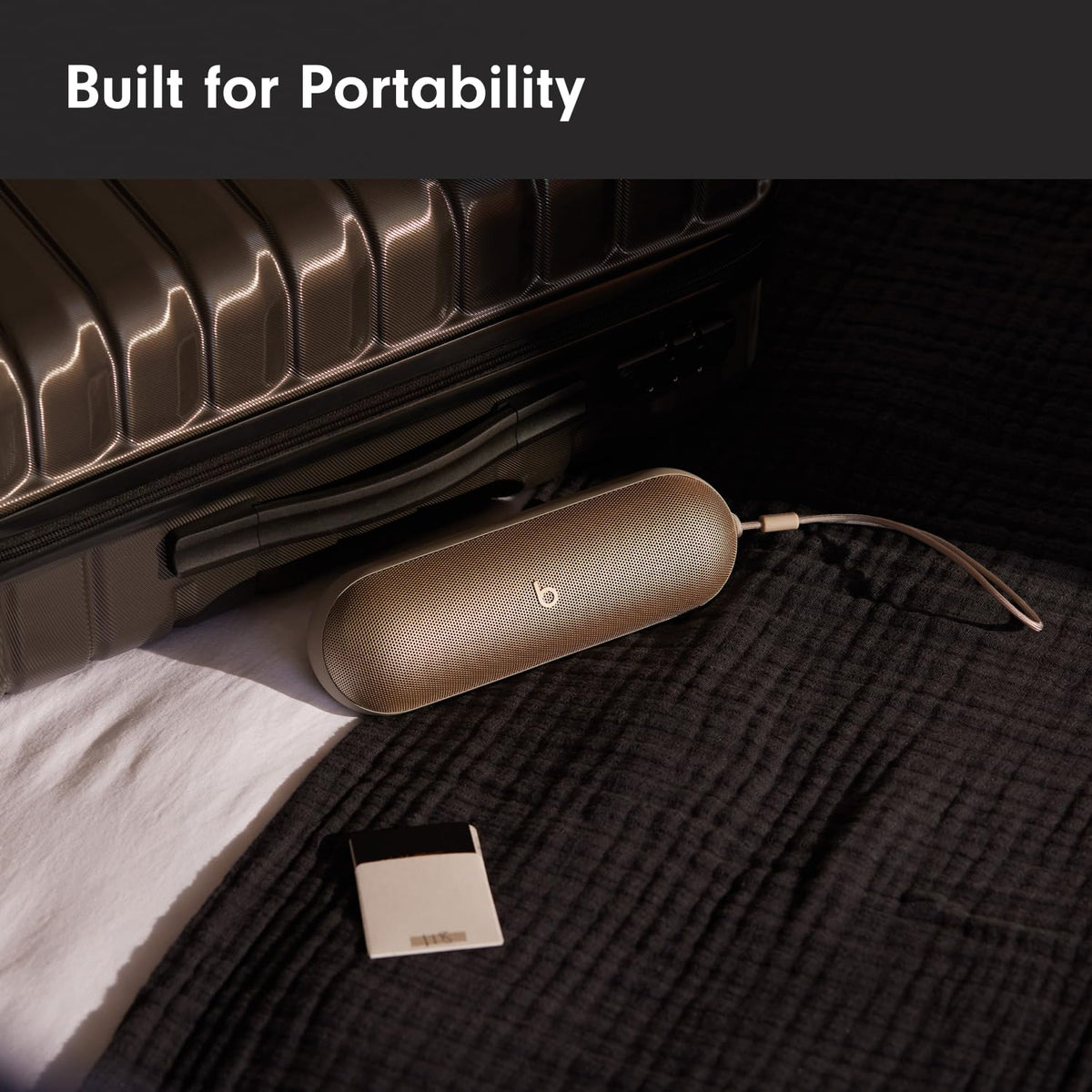 Beats Pill Campagne Gold with lanyard attachment for easy carrying during travel.
