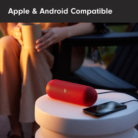 Two Beats Pill speakers in Amplify mode for larger, immersive sound in red.