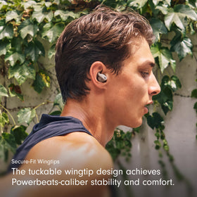 Beats Powerbeats Fit case open demonstrates portable charging for travel.